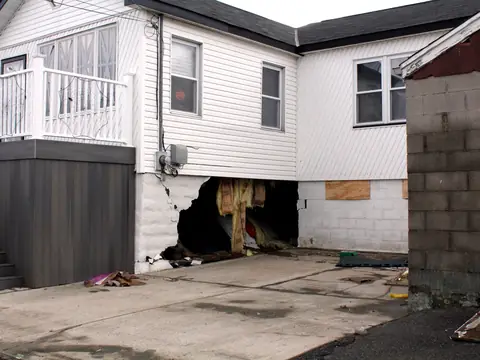 A house in Howard Beach, Queens, with its foundation wall broken open after Hurricane Sandy