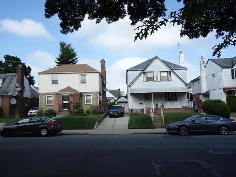 Detached houses with small lawns on a residential street in eastern Queens