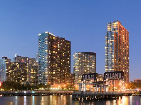 Apartment towers on the Long Island City waterfront at dusk, seen across the East River