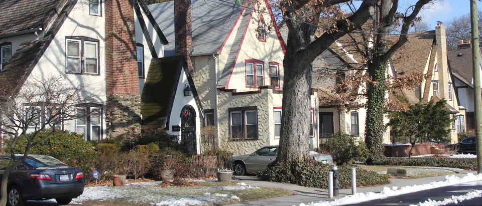 Tudor-style houses under tall trees in Addisleigh Park, St. Albans, Queens
