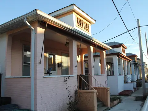 A row of bungalows with porches on a narrow street in the Rockaways